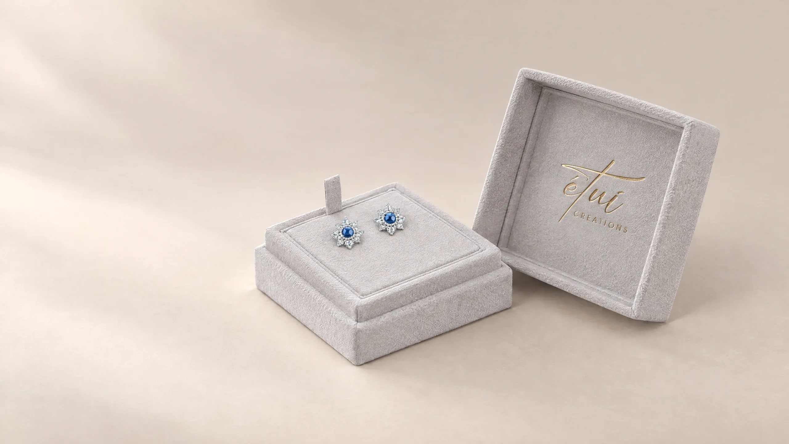 Open box in Grey: lid beside the base, earrings in the insert